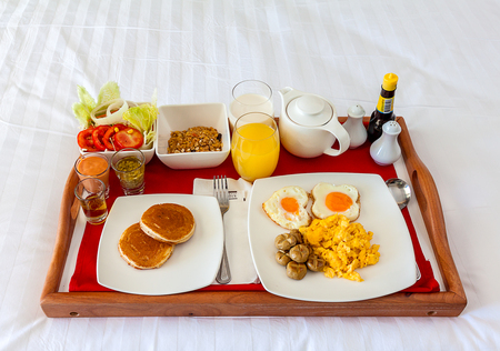 Breakfast set in tray on bed for guest who rest in hotelのeditorial素材