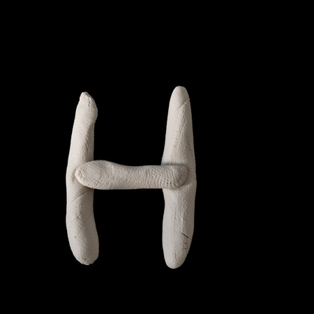 Alphabet H mold by clay on black with clipping pathの写真素材