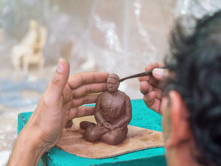 Artist making detail of resin female figure by using epoxy resin