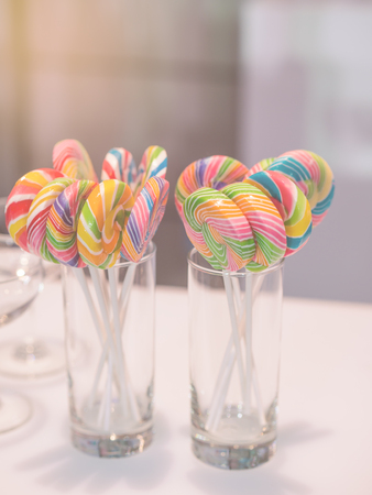 Lollipop in glass on white table with vintage toneの写真素材