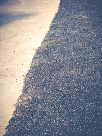 Close up asphalt road repair. Repair pavement and laying new asphalt patching method outdoors.の写真素材