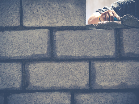 Manson or Brick builders are building walls in Thailandの写真素材