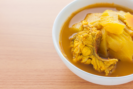 Yellow curry with fish and papaya,a popular local food in sounthern of Thailandの写真素材