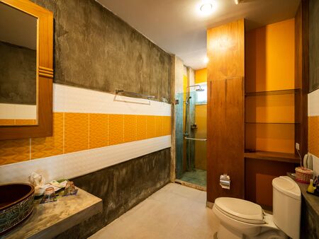 Luxury bathroom with sanitary ware decorate with brown wood.の写真素材