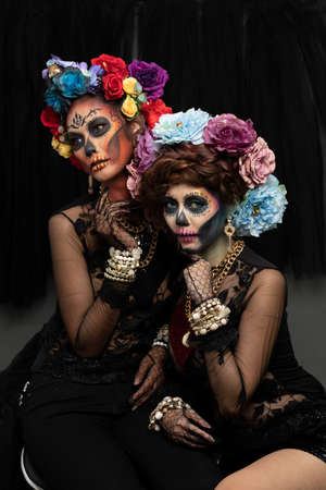Female models with a sugar skull makeup dressed with flower crown. Halloween conceptの写真素材