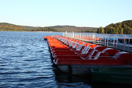 moored at the dock, red pedal boats の写真素材