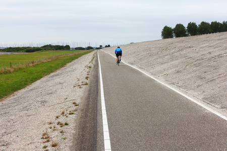 A fortified North Sea dike with bicycle path in the Netherlandsの写真素材