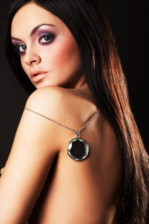 Fashion girl posing on dark background - portraitの写真素材