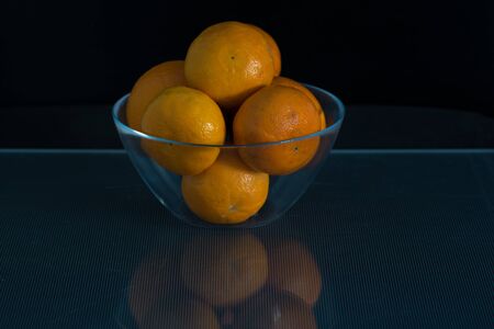 Tangerines in the glass jarの写真素材