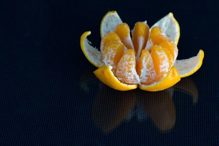 Fresh tangerine open on the tableの写真素材