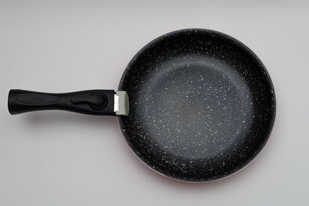 frying pan made from red ceramic with a white background. long lasting frying pan. non-stick frying pan. frying without oil.の写真素材