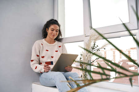 Woman with credit card and tablet buying in internet. Shopping onlineの写真素材