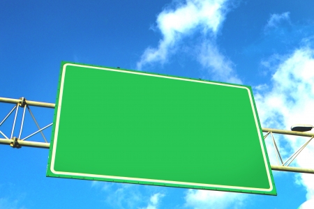 Blank green overhead traffic sign with copyspace for your text or destination against a cloudy sunny blue skyの写真素材