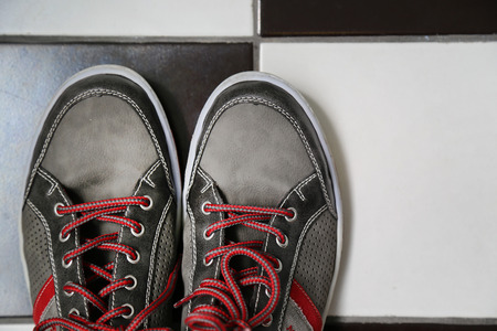 gray shoes with vivid red lacesの写真素材