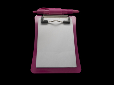 Small red Notepad isolated on black backgroundの写真素材