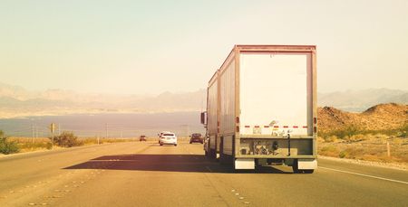 Truck and cars on US highway route on with afternon sunlightの写真素材