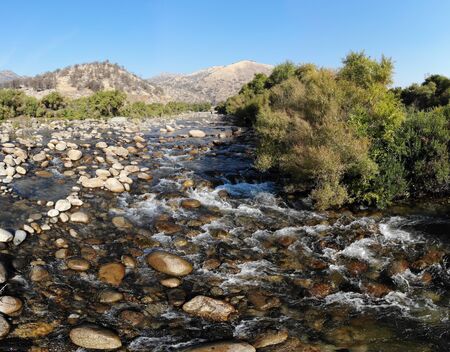 A river with pebbles from a low angleの写真素材