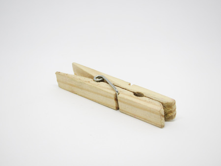 wooden clothes peg on a white background (selective focus)の写真素材