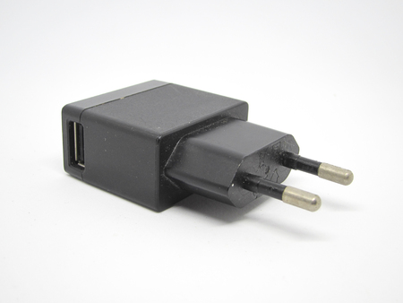 usb mobile phone charger on a white background (selective focus)の写真素材