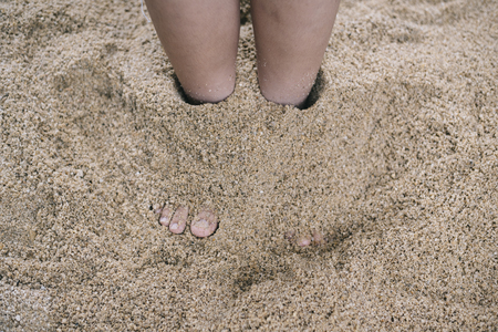 kid playing with sand.kid growth or development conceptの写真素材
