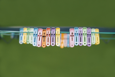 plastic clothespin hanging on the wire.women,mother,housewife life conceptの写真素材