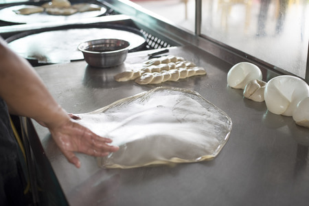 preparing,frying,cooking or making the malaysian flatbread,also known as roti canai.famous and...