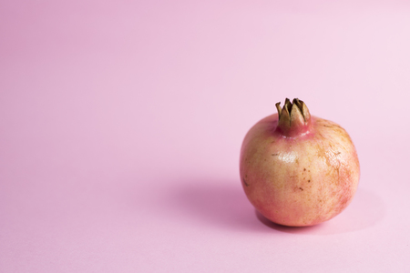 pomegranate fruit on a pink background.の写真素材