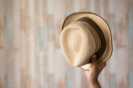 asian hand showing hat.clothing accessories and travel conceptの写真素材