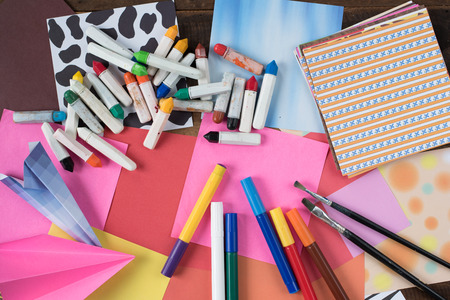 creativity concept - crayon,colorful paper,colour pencil,watercolor,paint brush on wooden...