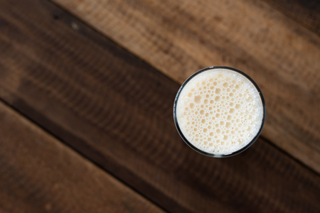 milk in a glass on wooden table background. a glass of cow milk. healthy drink conceptの写真素材
