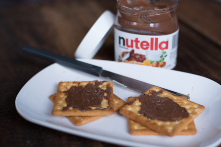 selangor, Malaysia - Jan 9th 2018 : nutella chocolate spread on wooden table. Nutella is manufactured by the Italian company Ferrero that was first introduced in 1965のeditorial素材