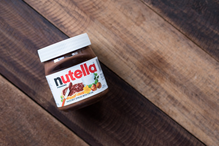 selangor, Malaysia - Jan 9th 2018 : nutella chocolate spread on wooden table. Nutella is manufactured by the Italian company Ferrero that was first introduced in 1965のeditorial素材