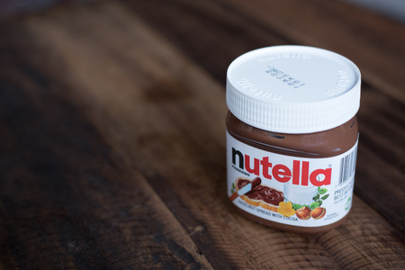 selangor, Malaysia - Jan 9th 2018 : nutella chocolate spread on wooden table. Nutella is manufactured by the Italian company Ferrero that was first introduced in 1965のeditorial素材