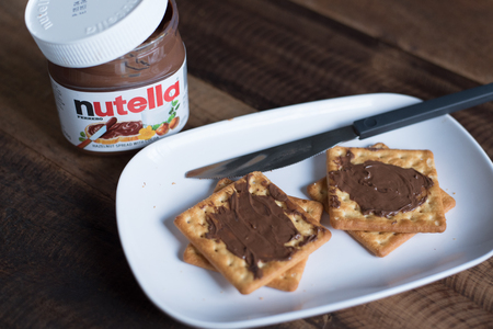selangor, Malaysia - Jan 9th 2018 : nutella chocolate spread on wooden table. Nutella is manufactured by the Italian company Ferrero that was first introduced in 1965のeditorial素材