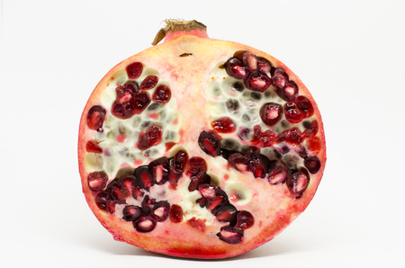 cross section of freah pomegranate fruit isolated on white backgroundの写真素材