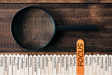 Magnifying glass and wooden sticks With LIFESTYLE related word. focus on lifestyle conceptの写真素材