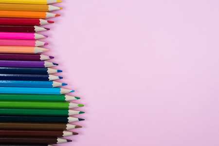 Colored pencils arrangment isolated on pink background.の写真素材