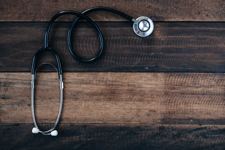 Stethoscope on wooden table background. medical health conceptの写真素材