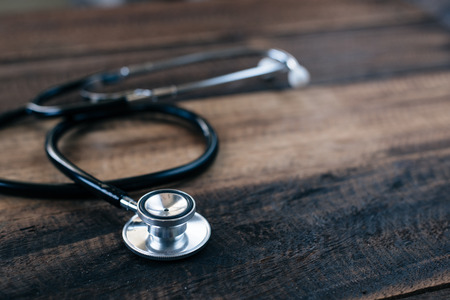 Stethoscope on wooden table background. medical health conceptの写真素材