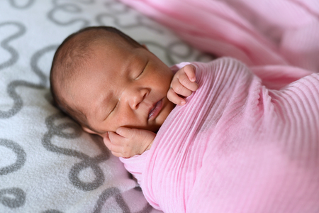 asian newborn baby sleeping in pink cloth. life conceptの写真素材
