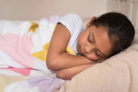 young little asian girl sleeping lying on bed in her bedroom. sleep conceptの写真素材
