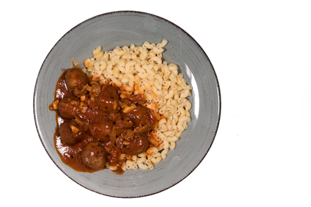 macaroni with meatballs and ketchup in a plate isoated on white background. food gastronomy conceptの写真素材