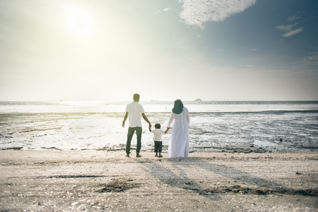 happy family having fun time together at the beach having nice sunset view located in Pantai Remis,Kuala selangor,selangor,malaysia. family conceptの写真素材