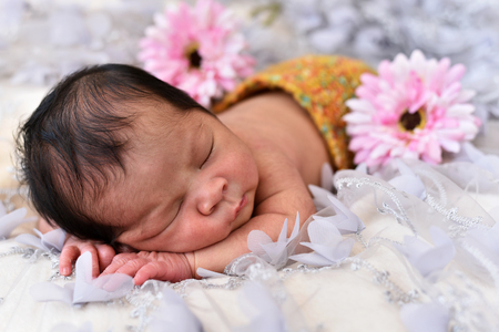 asian little baby girl newborn sleeping on a lace with flower pattern. newborn photo conceptの写真素材