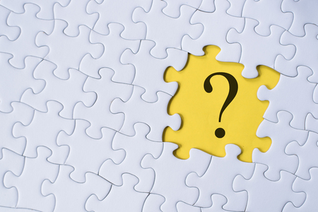 question mark on jigsaw puzzle with yellow background. question, faq and q&a conceptの写真素材