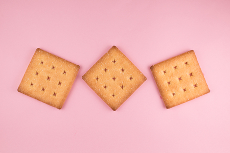 top view of three sugar cracker isolated on pink background. food and snack conceptの写真素材