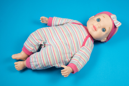 doll isolated on blue bakground. childhood conceptの写真素材