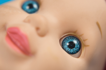 macro closeup of doll blue eye (selective focus). childhood conceptの写真素材