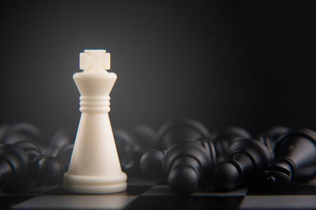 chess set on chess board. white king defeat all. power, hero and leadership concept. soft and selective focusの写真素材