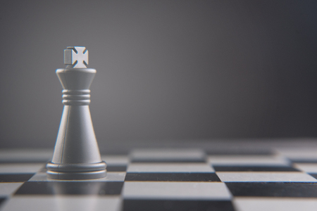 chess king piece standing alone. power and leadership concept. selective and soft focusの写真素材